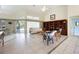 Spacious living room with tile flooring, a bookcase, and sliding doors to the patio at 150 N Oxford Dr, Englewood, FL 34223