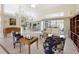 Living room with tile floors, view to the dining area, patio access, and comfortable seating at 150 N Oxford Dr, Englewood, FL 34223