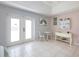 Bright and airy main bedroom with tile floors and access to the backyard at 150 N Oxford Dr, Englewood, FL 34223