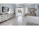 Light-filled main bedroom showcasing tiled floors, a sliding door view of the pool, and stylish decor at 150 N Oxford Dr, Englewood, FL 34223