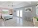 Relaxing main bedroom featuring tile floors, soft colors, and a ceiling fan at 150 N Oxford Dr, Englewood, FL 34223