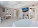 Main bedroom featuring tile floors, a TV, and decorative furnishings at 150 N Oxford Dr, Englewood, FL 34223