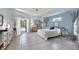 Serene main bedroom with light blue walls, tiled flooring, and sliding glass doors leading to the pool area at 150 N Oxford Dr, Englewood, FL 34223