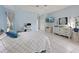 The bright and airy main bedroom features a work space, tiled floors, and light blue walls at 150 N Oxford Dr, Englewood, FL 34223