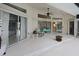 Inviting patio with sliding glass doors, comfortable seating, and ceiling fan at 150 N Oxford Dr, Englewood, FL 34223