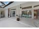 Relaxing covered patio with comfortable seating and views through sliding glass doors at 150 N Oxford Dr, Englewood, FL 34223