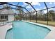 This screened pool offers a delightful view of the surrounding trees and sky at 150 N Oxford Dr, Englewood, FL 34223