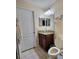 Well-lit bathroom with tiled floors, granite countertop, framed mirror, and a functional toilet at 15408 Feather Star Pl, Ruskin, FL 33573