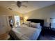 Spacious main bedroom features a ceiling fan and an ensuite bathroom at 15408 Feather Star Pl, Ruskin, FL 33573