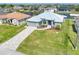 Aerial view of home, well-manicured front yard and brick-paved driveway at 15640 Melport Cir, Port Charlotte, FL 33981