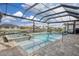 Screened-in pool with canal view and covered seating area at 15640 Melport Cir, Port Charlotte, FL 33981