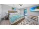 Bright bedroom featuring a TV and sliding door access to a private patio at 15652 Ruston Cir, Port Charlotte, FL 33981