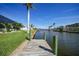 Private dock with lush landscaping offering direct access to the canal for boating and waterside enjoyment at 15652 Ruston Cir, Port Charlotte, FL 33981