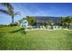 Charming home featuring a screened-in pool area, lush lawn, and tropical landscaping for ultimate relaxation and privacy at 15652 Ruston Cir, Port Charlotte, FL 33981