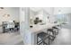 Kitchen bar features granite countertops, stainless steel appliances, wood-look floors, and adjacent office space at 15652 Ruston Cir, Port Charlotte, FL 33981