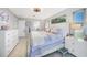 A spacious main bedroom featuring light gray wood floors and white furniture, creating a bright and airy atmosphere at 15652 Ruston Cir, Port Charlotte, FL 33981