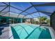 Relaxing screened-in pool with comfortable lounge furniture and a luxurious hot tub area for outdoor enjoyment at 15652 Ruston Cir, Port Charlotte, FL 33981