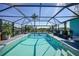 Inviting pool area with lush landscaping and a screened enclosure, ideal for enjoying sunny days at 15652 Ruston Cir, Port Charlotte, FL 33981