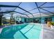 Beautiful pool area with plenty of seating and canal views, perfect for relaxing and entertaining at 15652 Ruston Cir, Port Charlotte, FL 33981