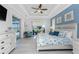 Coastal-themed bedroom with tray ceilings, a ceiling fan, and sliding doors to the outdoor living space at 16 Yellowhammer Dr, Placida, FL 33946