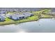 Aerial view of waterfront homes showcasing backyard landscaping with scenic pond views at 16273 Coconut Palm Dr, Port Charlotte, FL 33953
