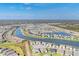 Panoramic aerial view of a vibrant residential community, showcasing homes, lakes, and green spaces at 16273 Coconut Palm Dr, Port Charlotte, FL 33953
