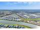 Panoramic aerial view of The Palms community featuring homes, lakes, landscaping and surrounding nature at 16273 Coconut Palm Dr, Port Charlotte, FL 33953