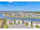 Enjoy the beauty of lakefront living in this aerial view of luxurious homes along a serene waterway at 16273 Coconut Palm Dr, Port Charlotte, FL 33953