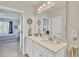 This bathroom features a large double sink vanity and a door that leads to the Primary bedroom at 16273 Coconut Palm Dr, Port Charlotte, FL 33953