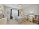 Light and airy bedroom features a ceiling fan, plantation shutters, a window with curtains, and neutral decor at 16273 Coconut Palm Dr, Port Charlotte, FL 33953