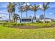 Elegant community sign for The Palms, surrounded by lush landscaping and manicured lawns at 16273 Coconut Palm Dr, Port Charlotte, FL 33953
