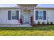 Charming front entryway with a stone accent wall and light blue front door at 16273 Coconut Palm Dr, Port Charlotte, FL 33953