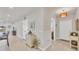 Inviting hallway features neutral tones, tiled floors, and elegant decor, leading to various rooms in the home at 16273 Coconut Palm Dr, Port Charlotte, FL 33953
