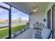The screened patio offers serene water views, comfortable seating, and a ceiling fan for comfort at 16273 Coconut Palm Dr, Port Charlotte, FL 33953