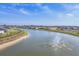 Scenic pond view with fountain and surrounding homes in a vibrant community at 16273 Coconut Palm Dr, Port Charlotte, FL 33953