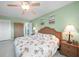 Inviting bedroom with calming green walls, ceiling fan, and comfortable furnishings create a relaxing retreat at 1690 Edith Ave, Englewood, FL 34223