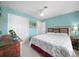 Bright bedroom featuring an eclectic headboard, charming decor, and a ceiling fan at 1690 Edith Ave, Englewood, FL 34223