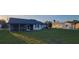 Home exterior with a large backyard and screened-in porch area at 172 Coblentz St, Port Charlotte, FL 33954