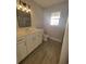 Clean bathroom featuring a white vanity, framed mirror, and tile flooring at 172 Coblentz St, Port Charlotte, FL 33954