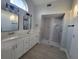 Modern bathroom featuring double vanity sinks, a tiled shower, and a tiled floor at 172 Coblentz St, Port Charlotte, FL 33954