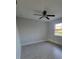 Cozy bedroom with neutral walls, ceiling fan, and tile flooring, offering a serene retreat at 172 Coblentz St, Port Charlotte, FL 33954