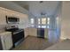 Spacious kitchen with white cabinetry, stainless steel appliances, and bright natural light at 172 Coblentz St, Port Charlotte, FL 33954