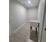 Well-lit laundry room features wood look tile floors and a utility sink at 172 Coblentz St, Port Charlotte, FL 33954