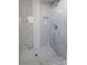 Walk-in shower featuring elegant marble tiling, a built-in niche, and modern fixtures at 172 Coblentz St, Port Charlotte, FL 33954