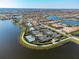 A captivating aerial view of the community showcasing tennis courts, pool, and scenic landscaping at 19241 Serafina St, Venice, FL 34293