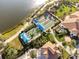 Aerial view of bocce ball courts, walking trails, and meticulously landscaped community grounds near a lake at 19241 Serafina St, Venice, FL 34293
