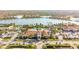 Aerial view of a luxury community featuring a large pool, clubhouse, lake, and beautiful landscaping at 19241 Serafina St, Venice, FL 34293