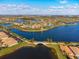 Expansive aerial view showcasing the community's lakes, lush landscaping, community pool, and beautiful residential homes at 19241 Serafina St, Venice, FL 34293