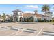 Beautiful clubhouse with manicured landscaping, a tile roof, and ample parking at 19241 Serafina St, Venice, FL 34293
