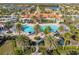Aerial view of the community pool featuring palm trees, plenty of lounge chairs, and beautifully landscaped grounds at 19241 Serafina St, Venice, FL 34293